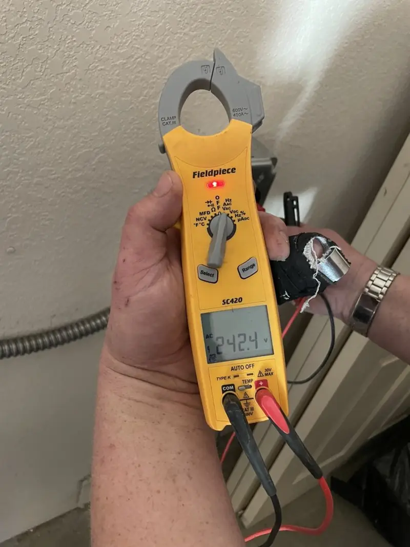Voltage testing with clamp meter during Electrical Installation Services in Ulysses